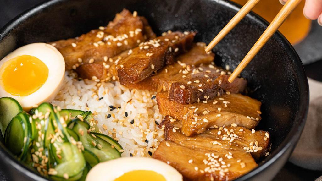 Pork Belly Don · A generous serving of our braised pork belly slices, served with tender medium grained rice, an ajituske soft boiled egg, and vegetables.