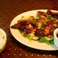 Crispy Duck / Cơm Vịt Quay · Half of a duck marinated with salt, black pepper, garlic and house spices. Served on a bed o...