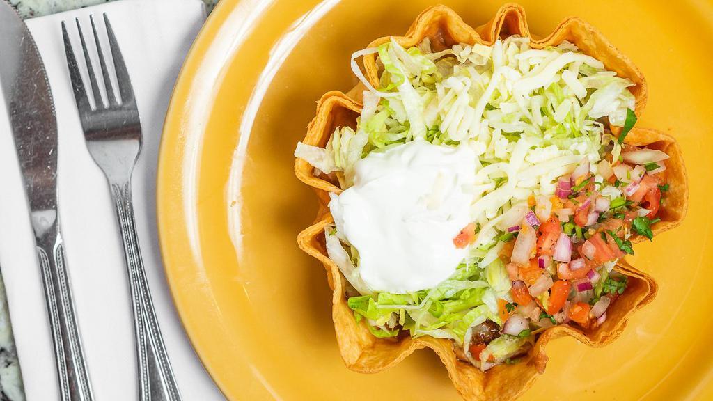 Taco Salad · Rachel Ripken's (Cal Ripken Jr.'s daughter) favorite! A crispy flour tortilla filled with ground beef. fried beans, lettuce, tomatoes, grated cheese and sour cream.