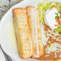 Chimichangas · Two flour tortillas, deep fried or soft, filled with beef tips or pulled chicken. Topped wit...