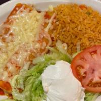 Shrimp Enchiladas · Two shrimp enchiladas topped with cheese. Served with Spanish rice, lettuce and sour cream.