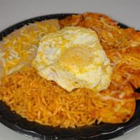 Chilaquiles Breakfast · Corn tortillas, with red or green sauce topped with 2 over easy eggs. Served with rice and b...