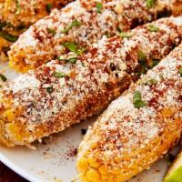 Elotes (Mexican Street Corn) · Fire roasted corn with Parmesan and paprika mayo dressing, served in a 5.5 oz container.
