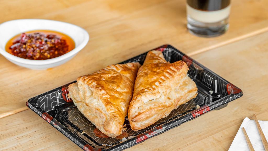 Pate Chaud Meat Pies · two savory pork fillings encased in a rich and flakey puff pastry.