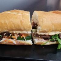 Grilled Sliced Beef Banh Mi · Banh mi (baguette) are made from scratch and bake fresh daily and filled bánh mì with our ma...