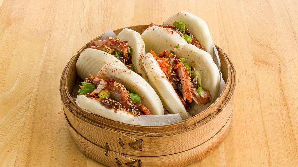 Bbq Pork Bun Wrapped · A soft and fluffy bun filled with BBQ pork, pickled carrot daikon, green onions, hoisin sauce, and crunchy onions crumble.