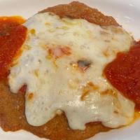 Chicken Parmigiana · Breaded chicken with tomato sauce and mozzarella, served with pasta