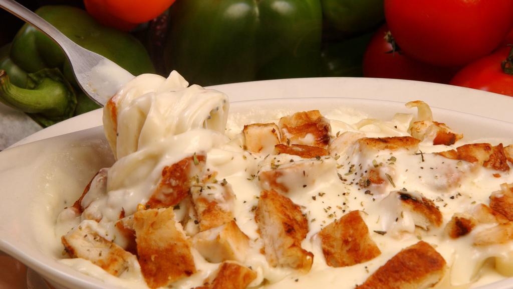 Fettuccine Alfredo · fettuccine noodles covered with signature creamy alfredo sauce and 3 pieces of garlic or regular bread