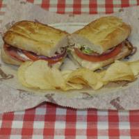 Hot Ham And Cheese Sub · Crisp lettuce, mayo, tomato, onion and cheese on a golden brown bun.