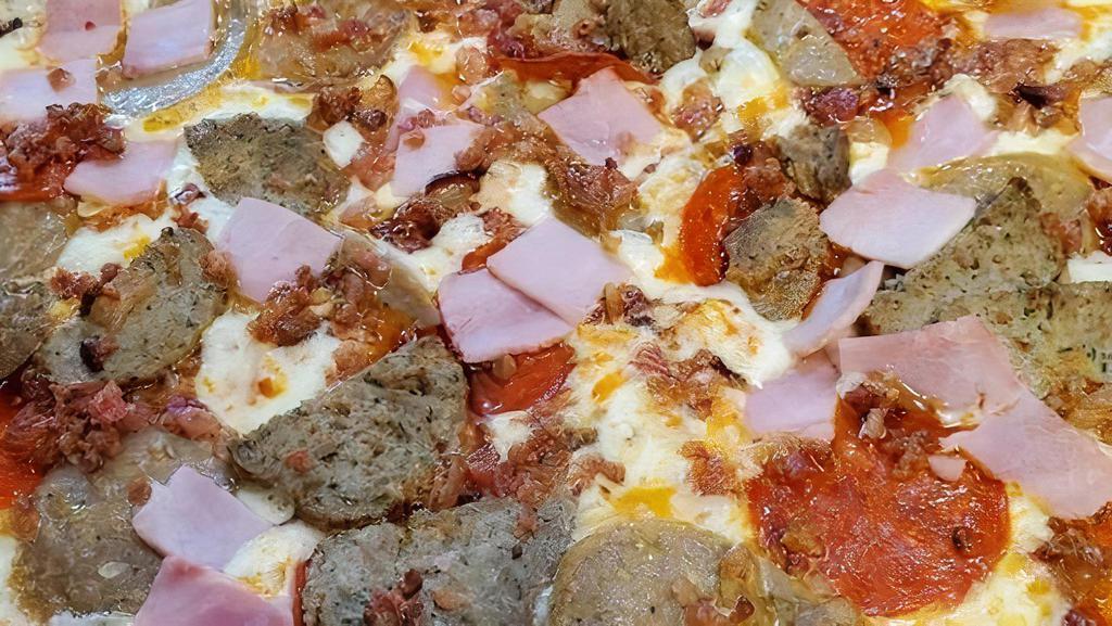 Small Mighty Meat Pizza · Homemade pizza sauce, pepperoni, sausage, ham, meatball, and bacon