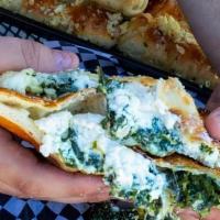 Spinach Calzone · Grande mozz cheese with Grande ricotta, and Spinach, baked to golden brown served with a sid...