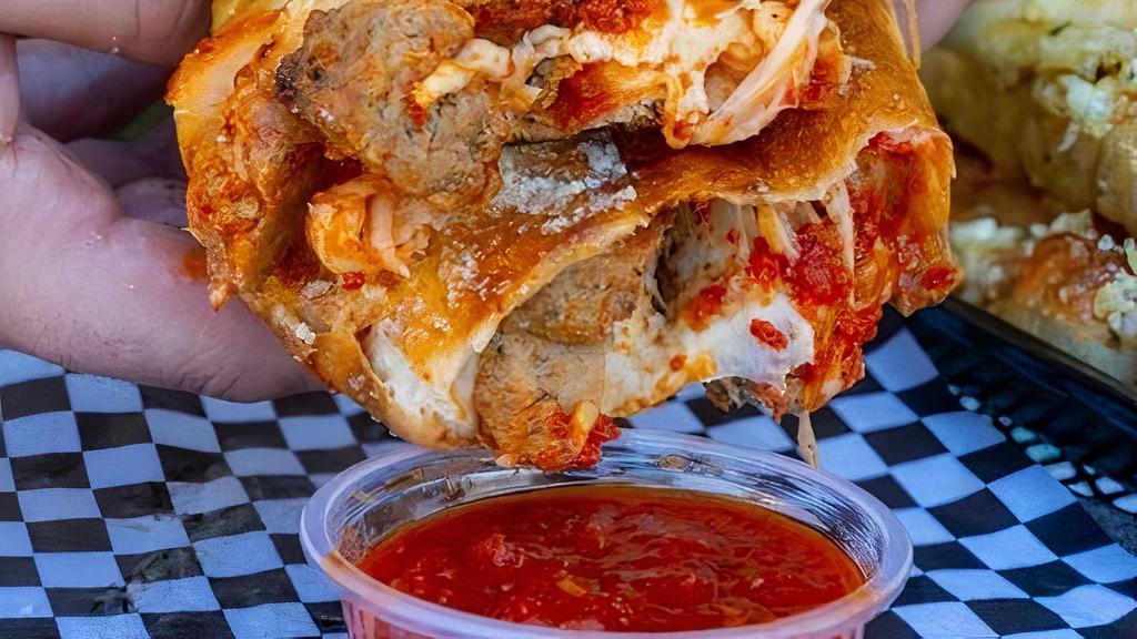 Meatball Parm Boli · Grande Cheese with mamas meatballs  tossed in homemade marinara, baked to perfection, served with a side of homemade sauce