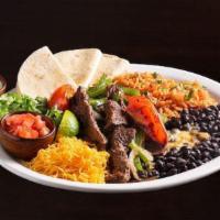 Steak Fajitas · Marinated strips of steak sautéed with onions, green pepper & tomatoes. Served with Spanish ...
