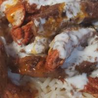 Chicken And Lamb  Over Rice Combo (Halal) · Chicken and lamb marinated in special herbs over the grill with fried onion, tzatziki sauce ...