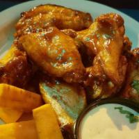 Habanero Chicken Wings · Habanero rubbed wings fried and tossed in a spicy BBQ sauce then finished on the grill, serv...