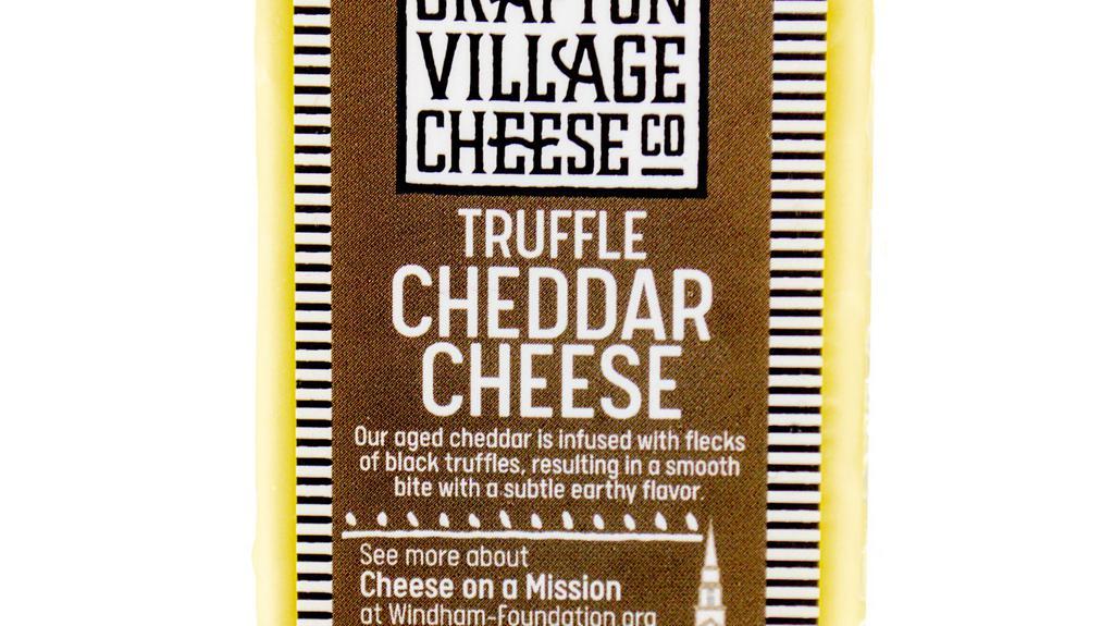 Truffle Cheddar |  Grafton · One of our all-time favorite cheeses, this mild Vermont raw cheddar takes on earthy, forest floor nuances with its truffle flavors. It is a perfect pairing for a Beaujolais, Willamette Pinot Noir, or Burgundy, but really any light-bodied red will do.