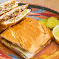 Cuban Sandwich  · slow cooked pork,  ham , cheese , pickles,  house mustard, served on pressed and toasted fre...