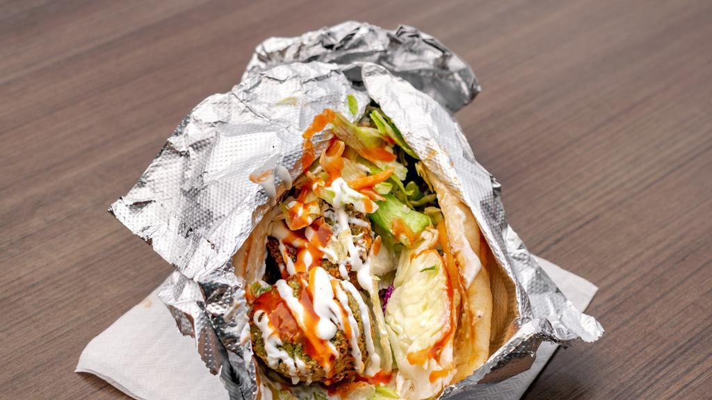 Falafel Sandwich · Falafel is a middle eastern dish made from chickpeas. Traditionally, falafel is deeply fried to yield a crispy texture and served in a pita with fresh, crunchy garnishes.