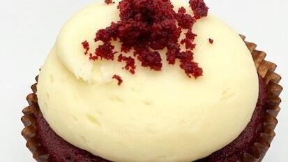 Red Velvet Cupcake · Red velvet cake with cream cheese frosting topped with red velvet crumbs.