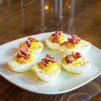 Bacon Deviled Eggs · 6 deviled eggs topped with bacon and smoked paprika