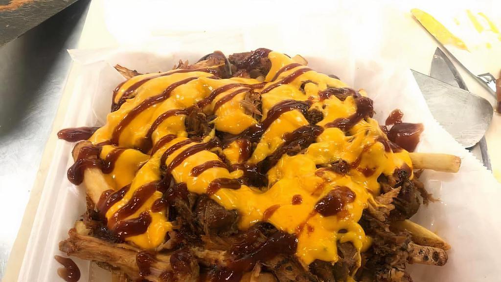 Kansas City Fries · Large portion of fries served with fresh BBQ pulled pork made in house then smothered in creamy cheddar cheese sauce