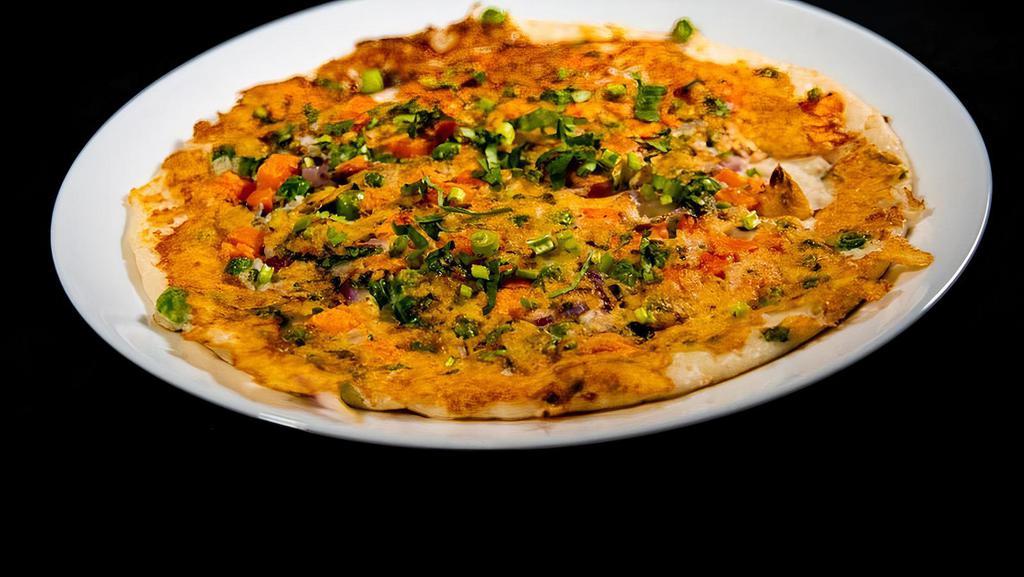 Uthappam Mixed · Rice and lentil batter thick pancake with onion, tomato and chili toppings. Vegan and Gluten free