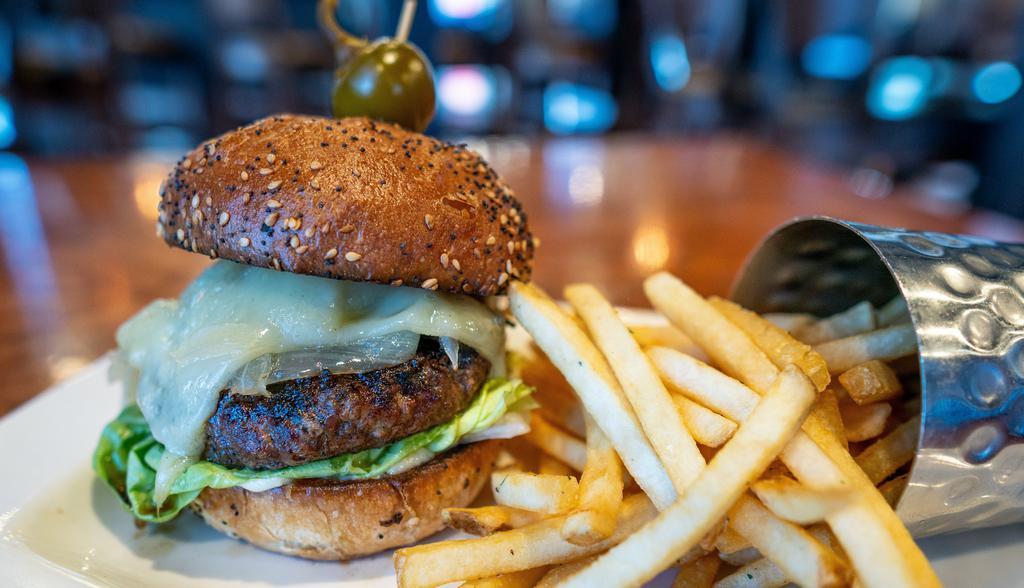 Wagyu Burger · Indulgent ground wagyu seared to perfection then topped with mushroom conserva, caramelized onions and melted swiss cheese, set atop a toasted everything bun dressed with rosemary garlic aioli and butter lettuce.