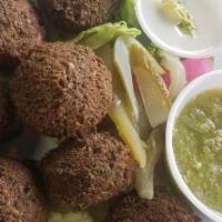 Falafel Salad · Lettuce, tomato, and cucumber topped with three pieces falafel drizzled with a house dressin...