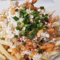 Greek Fries · Topped with crumbled feta cheese, green onion, sumac, drizzled with garlic mayo, and hot sau...