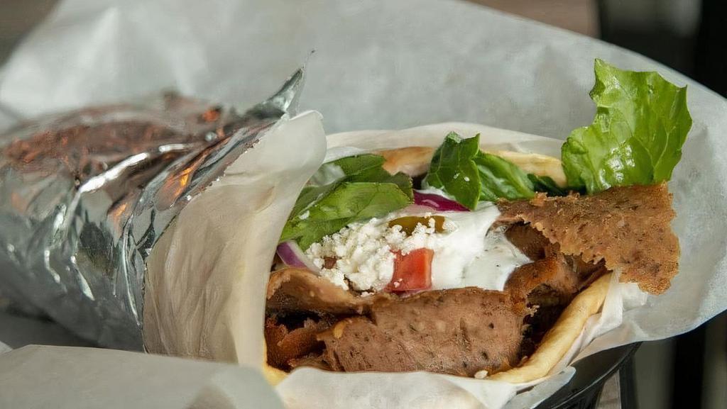 Beef & Lamb Gyro Wraps · Seasoned beef and lamb mix cooked on a vertical rotisserie, served with tzatziki sauce, feta, and red onions. Served with lettuce, pickles, and tomato wrapped in a warm pita.