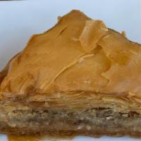 Traditional Baklava · Phyllo dough stuffed with walnuts and pistachio soaked in a honey syrup.