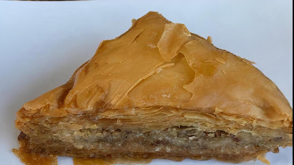 Traditional Baklava · Phyllo dough stuffed with walnuts and pistachio soaked in a honey syrup.