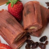 Strawberry Raisin & Cream Cheese Tamales · Fresh strawberry, cinnamon, and raisin masa filled with cream cheese and wrapped in a corn h...