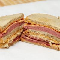 Super Reuben (Sandwich) · Hot corned beef and spiced beef pastrami, melted Swiss cheese, sauerkraut and 1000 island dr...