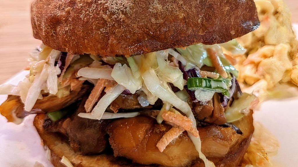 Shoyu Chicken Sandwich · Tender Shoyu Chicken Thigh with Creamy Cabbage & Pineapple Slaw and Spicy Mayo on Toasted Potato Bun. Served with Choice of Mac Salad or Green Salad with Creamy Sesame-Shoyu Dressing.