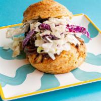 Brisket Biscuit · brisket, Alabama white barbecue sauce, caramelized onion, and crunchy cabbage slaw.