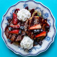 The Frenchie · Biscuit style french toast with berry jam, whip, berries and maple syrup.