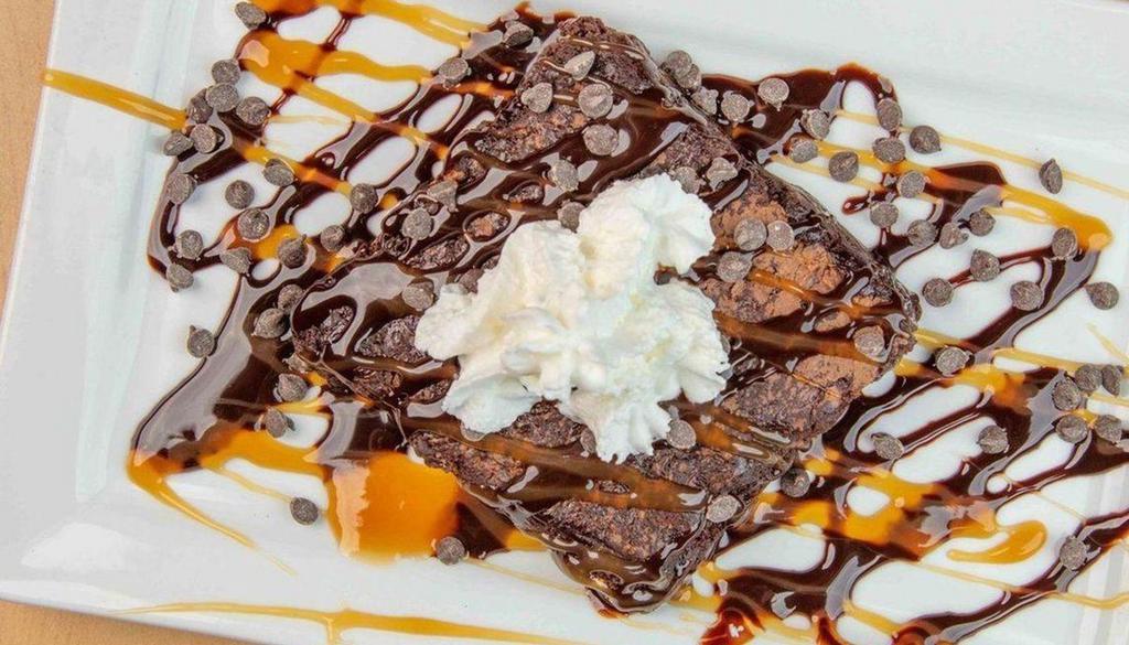 Ghirardelli Brownie · Ghirardelli double-chocolate fudge brownie topped with whipped cream, chocolate syrup, caramel sauce, and mini chocolate chips.