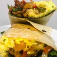 Fried Chicken Breakfast Wrap · Juicy Fried Chicken Tenders, Scrambled Eggs, Mixed Greens, Sauteed Peppers and Onions, Chees...