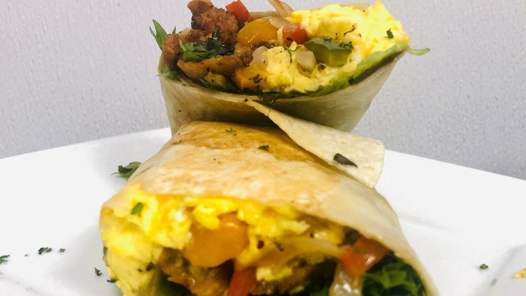Fried Chicken Breakfast Wrap · Juicy Fried Chicken Tenders, Scrambled Eggs, Mixed Greens, Sauteed Peppers and Onions, Cheese (Option with or without) on your Choice of wrap