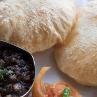 Choley Bhature · Two pieces. Deep fried bread made from fine white flour. Served with Delhi style chickpeas.