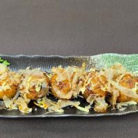 Takoyaki · Fried octopus dumplings with bonito flakes, mayo, eel sauce.