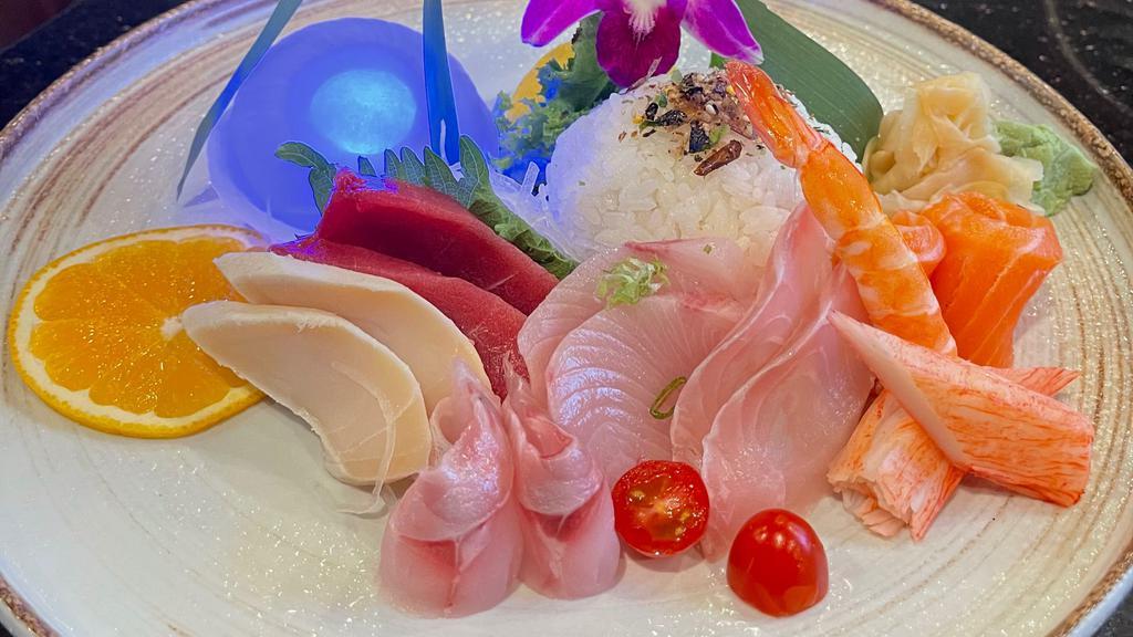 Chirashi · Salmon, tuna, white fish, kani, egg on top of rice bowl.