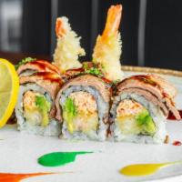Blazing Flame Roll · Shrimp tempura, spicy crab, avocado, seared filet steak on top with eel and spicy sauce.
