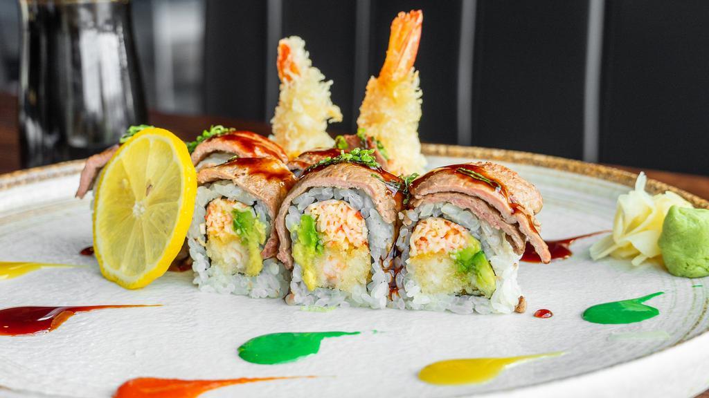 Blazing Flame Roll · Shrimp tempura, spicy crab, avocado, seared filet steak on top with eel and spicy sauce.
