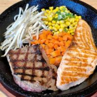 Surf & Turf · NY Steak and grilled salmon fillet, served with buttery corn, bean sprout, carrots, and rice.