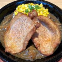 Pork Chops · Two slices of boneless pork chops.  Served with onion mushroom sauce, rice, corn, and topped...