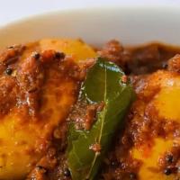 Hyderabadi Egg Masala · Boiled eggs cooked with curry leaves, red chilies, peanut and onion sauce.