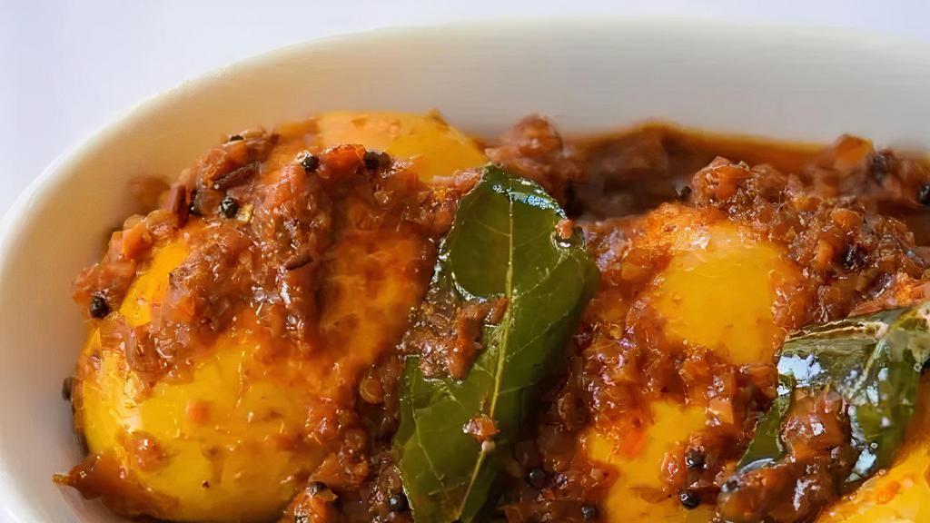 Hyderabadi Egg Masala · Boiled eggs cooked with curry leaves, red chilies, peanut and onion sauce.