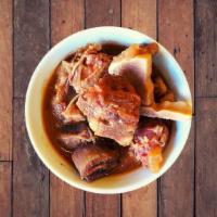 Goat Stew - Chivo Guisado · Goat stew, full of flavor served with our signature homemade hot sauce on the side. - Domini...